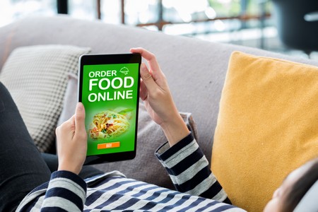 Order Food Online Concpet.woman Lying Down On Sofa Using Tablet See Restaurant Menu Online At Home.digital Technology Lifestyle.
