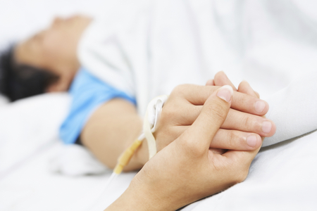 Holding Patient Hand In Hospital