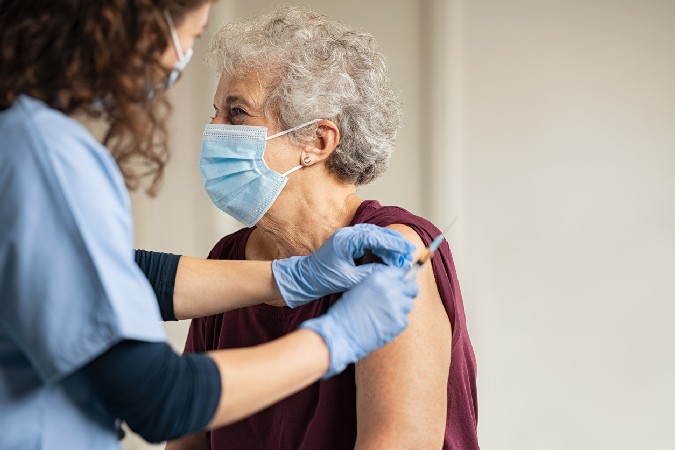 Doctor Giving Covid Vaccine To Senior Woman