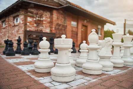 White Giant Chess Pieces On The Street. Chess. Street Game