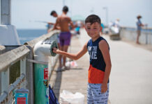 Young Angler Recylces Fishing Line In One Cba S Recycling Bins Located On Okaloosa Island Pier.