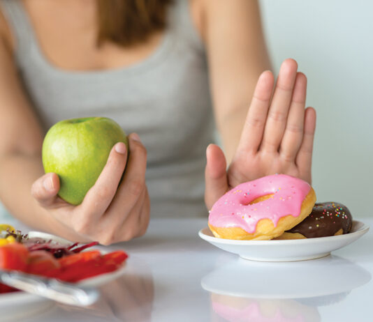 Dieting Or Good Health Concept. Young Woman Rejecting Junk Food Or Unhealthy Food Such As Donut Or Dessert And Choosing Healthy Food Such As Fresh Fruit Or Vegetable.