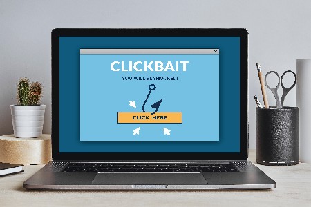 Clickbait Concept On Laptop Screen On Modern Desk